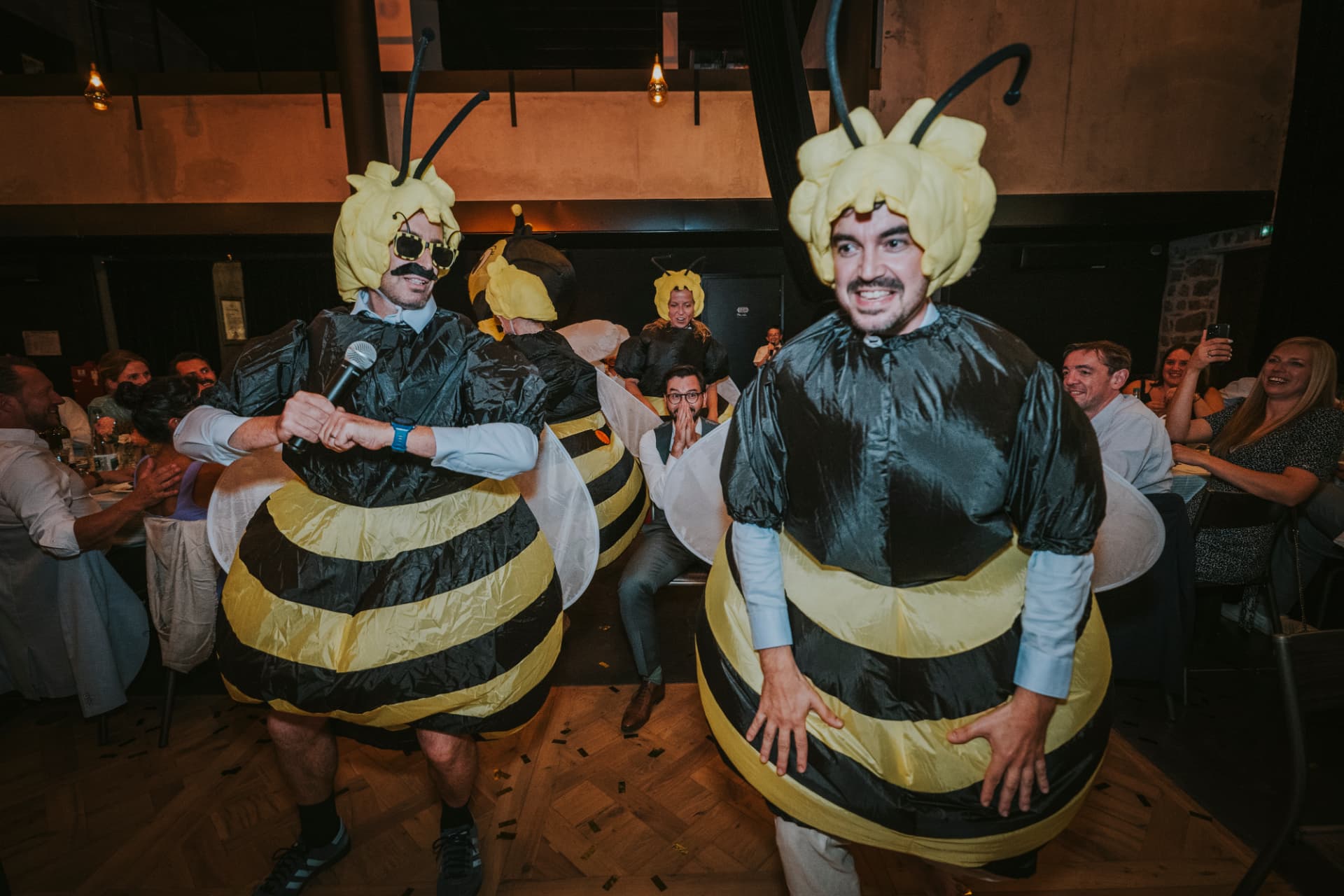 Guests dressed as bees during the wedding party — a playful moment